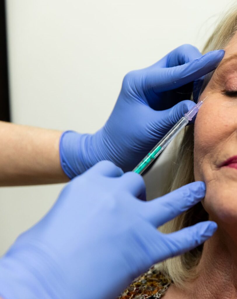 A Medical Grade Aesthetics injector administers Botox and lip filler in Freeport.