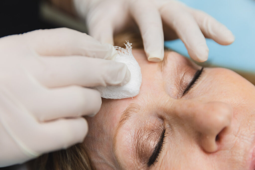 A woman having her face cleansed by a provider at Medical Grade Aesthetics, getting ready to receive one of their many options for medical grade facials near Janesville.