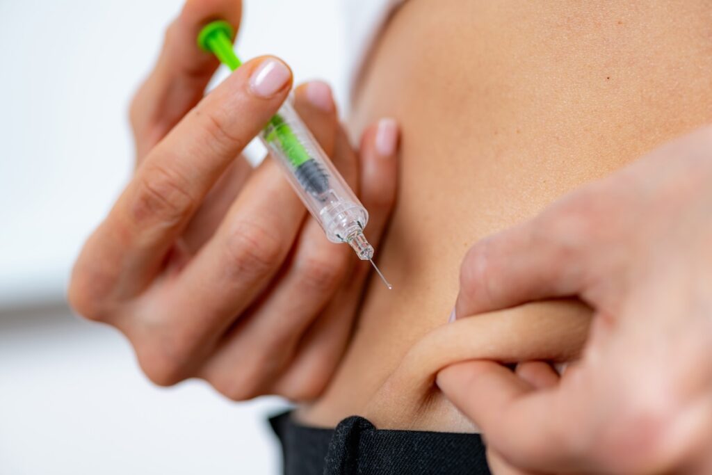 A woman self-injects her abdomen with semaglutide in Freeport