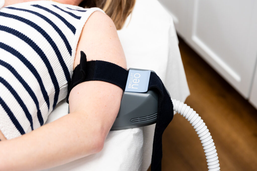A female patients at Medical Grade Aesthetics lying down while receiving Emsculpt NEO to improve her muscle mass while she is undergoing her personalized weight loss program in Beloit.