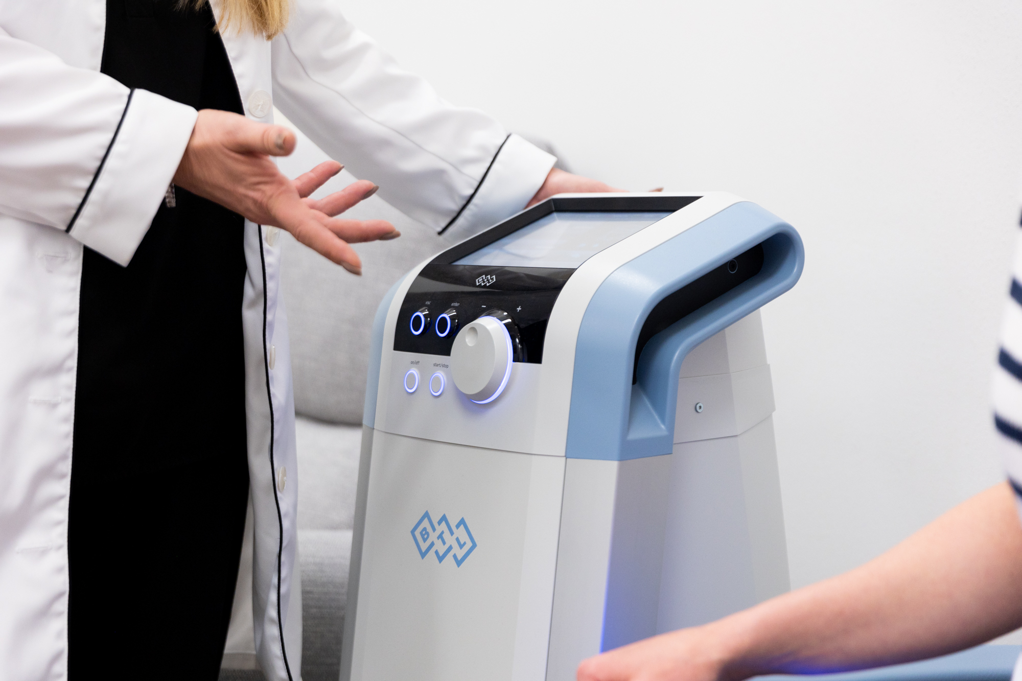 A provider modifies the intensity of the HIFEM energy during a patient's urinary incontinence treatment near Freeport.