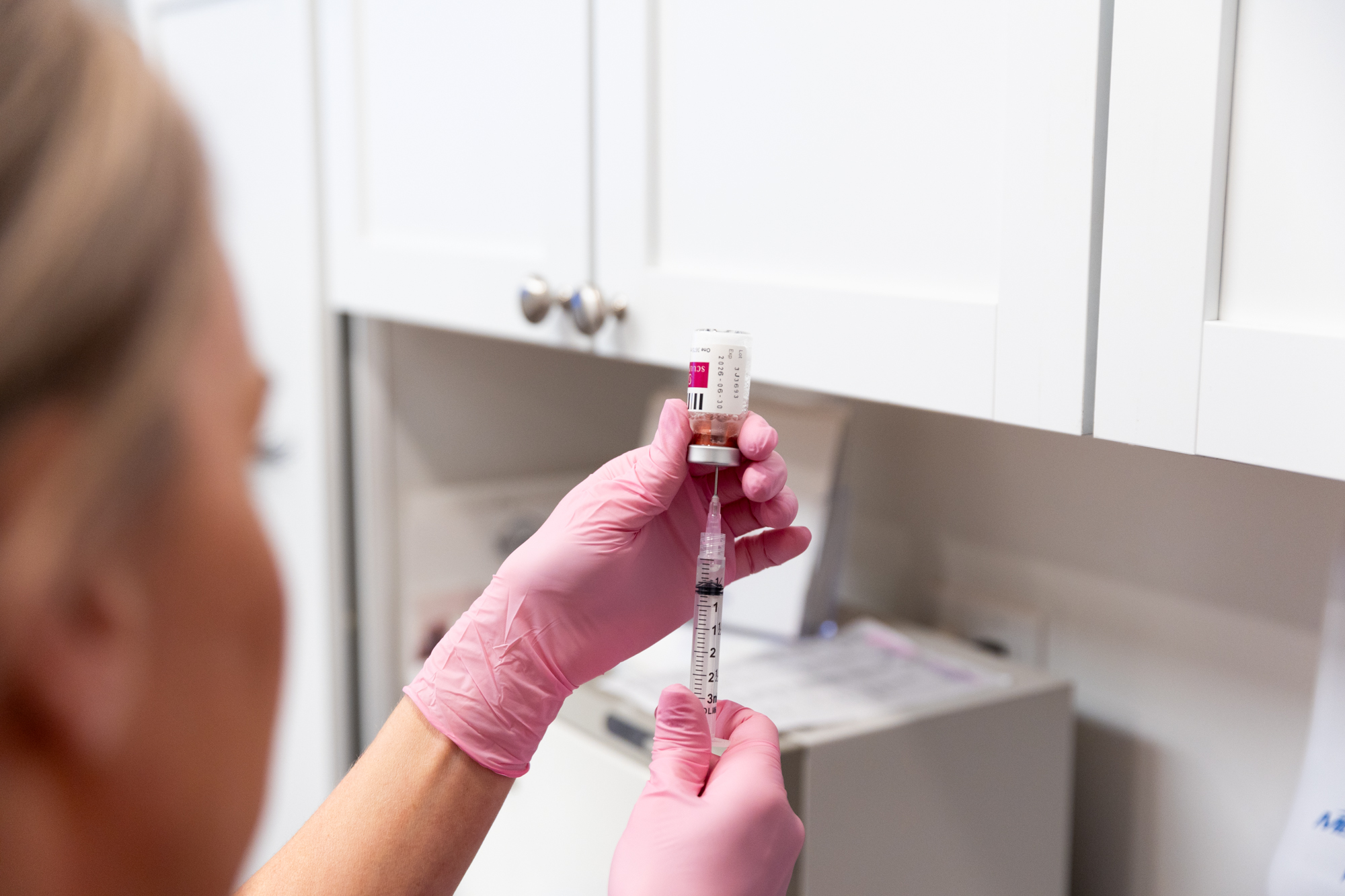 A Medical Grade Aesthetics provider prepares a syringe before administering cosmetic fillers in Beloit.