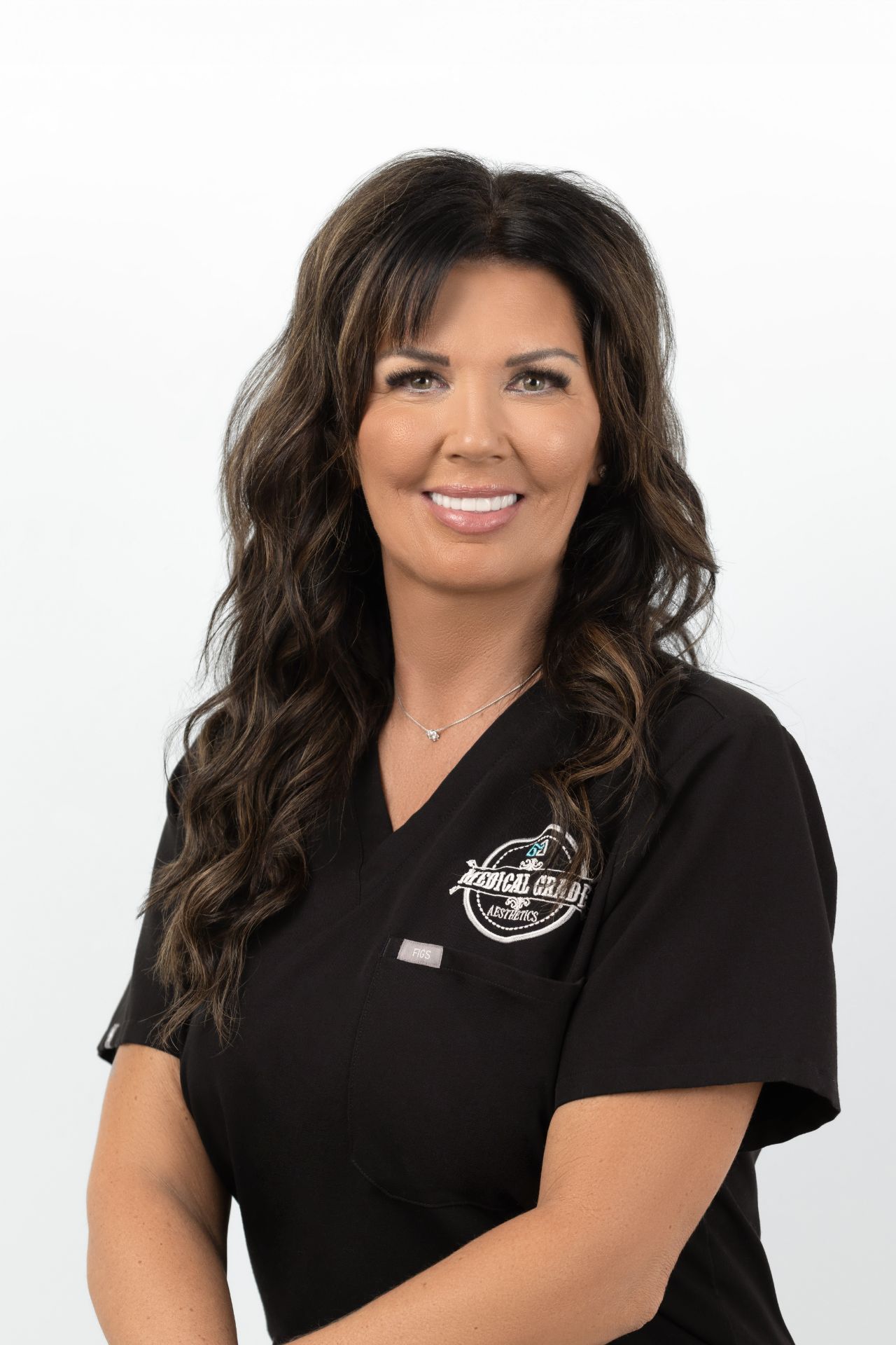 Brunette sitting and smiling at camera