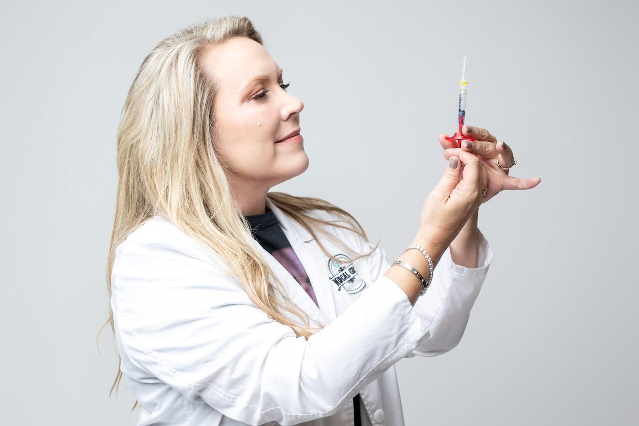 Dr. Jen Yeager prepares a syringe for hair restoration near Janesville.