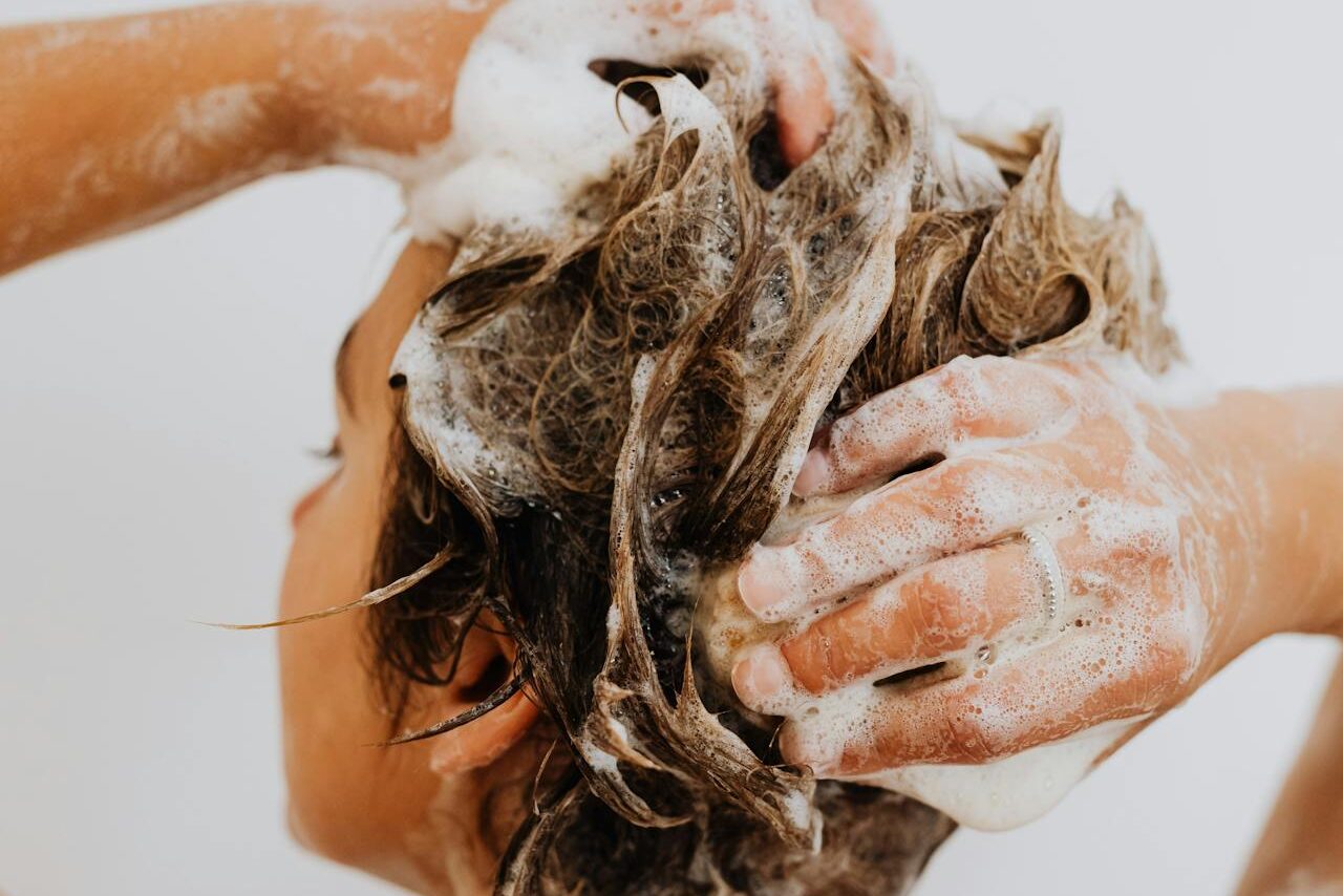 A patient uses a gentle shampoo after a session of PRP hair restoration near Janesville.