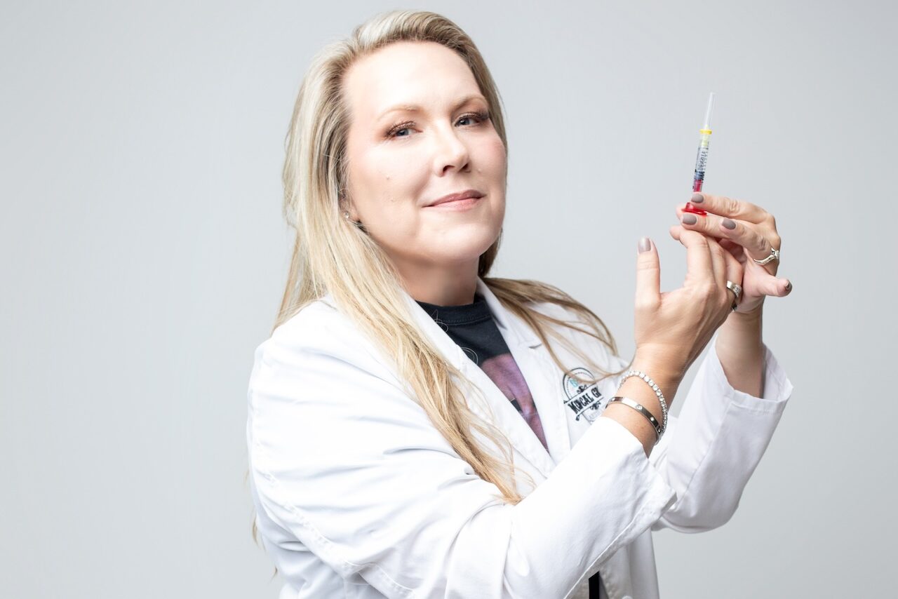 Dr. Jen Yeager holds a syringe of biostimulating filler, preparing to administer a patient's biostimulators in Janesville.